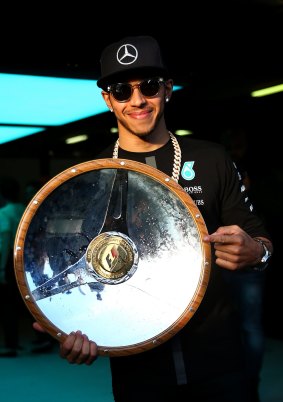 Fast: Lewis Hamilton displays his trophy.