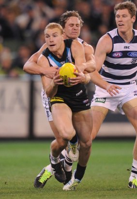 Geelong's Mitch Duncan tackles Port's Andrew Moore two years ago.