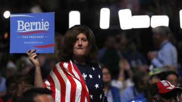Opposing groups can be urged on through propaganda and misinformation to become more militant. A delegate shows support for Senator Bernie Sanders.