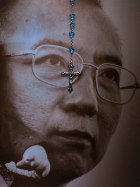 A rosary hangs over the portrait of the late Chinese Nobel Peace laureate Liu Xiaobo in Hong Kong.