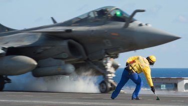 A French fighter jet taking off from the deck of France's aircraft carrier Charles De Gaulle, while the French defence ministry says it has bombed Islamic State in Mosul and Ramadi. 
