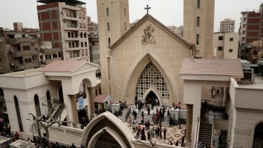 People gather outside the St. George's Church after a deadly suicide bombing, in the Nile Delta town of Tanta, Egypt.