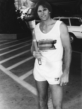 In 1984 decathlete Bruce Jenner poses with the Olympic Torch he carried through Lake Tahoe, Nevada. 