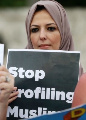 Protester Sanaa Alhagri hold a sign during a rally against President Donald Trump's executive order on Muslim immigration in Miami.