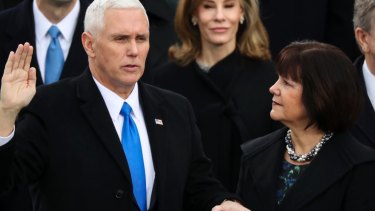 Vice-President Mike Pence is sworn in as his wife Karen holds the Bible during the 58th Presidential Inauguration at the US Capitol in Washington.