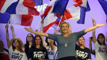 Marine Le Pen waves to supporters during a National Front meeting in September. 