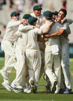 The Australian team and Starc (right) celebrates his last wicket - Yasir Shah -to win the match against Pakistan at the MCG on December 30.