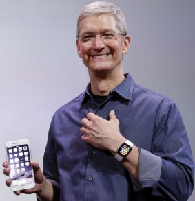 Tim Cook shows off the Apple Watch at last year's iPhone launch.