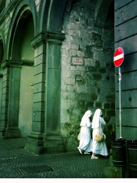 Two nuns walk through the old fortress city of Orvieto, Umbria, Italy.