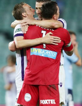 Perth Glory goalkeeper Danny Vukovic celebrates with teammmates in more winning times.