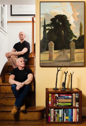 On the stairs: Eyes and Elliott with their favourite painting, Rick Amor's <i>The Gateway (The Man Who Walked Away)</i>.