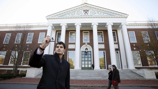 An unidentified man takes a photograph at the Harvard Business School in Boston, Massachusetts. The city has a history of innovation.