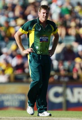 Casualty: James Faulkner shows discomfort before leaving the field injured against England.