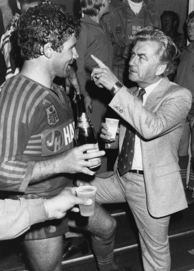 Prime Minister Bob Hawke shares a drink with Parramatta captain Steve Edge after the Eels' grand final win in 1983.