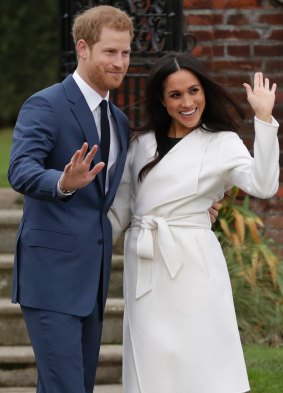 Prince Harry and his fiancee Meghan Markle pose for photographers at Kensington Palace in London after announcing their engagement.