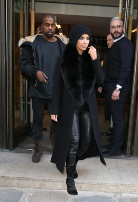 Kim Kardashian tries to conceal her new hairdo.