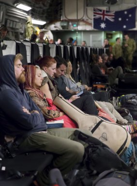 Australian citizens rest on board a RAAF aircraft after being evacuated from Kathmandu, Nepal.