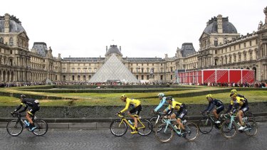 The riders, including the yellow jersey of Chris Froome, pass the Louvre during the last stage of the 2015 Tour de France.