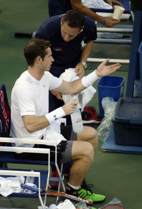 Andy Murray talks to the umpire during a break in play during which Kevin Anderson of South Africa left the court.