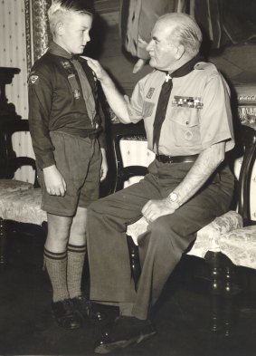 Sir William Slim, Chief Scout of the Commonwealth, presents Wolf Cub David Turnbull, 10, with the Silver Cross for Gallantry for rescuing two boys from drowning in the Murray 1958. 