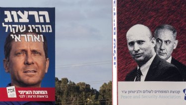 A poster of Zionist Union co-leader Isaac Herzog, left, alongside an anti-Netanyahu poster in Tel Aviv that shows the prime minister looking anxiously over the shoulder of far-right Jewish Home leader Naftali Bennett.  