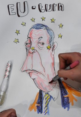 Artist and writer Brian John Spencer works on a cartoon featuring Nigel Farage at the Belfast count.
