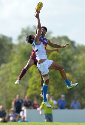 Hang time: Brisbane's Archie Smith and Suns' Tom Nicholls fly high.