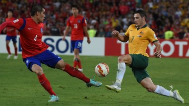 Impressive workrate: Socceroo Mathew Leckie takes on South Korean defender Jim Ju Young during the Asian Cup final.