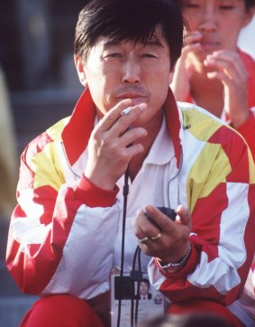 Ma Junren watching his Chinese women's distance running team at the Asian Games in Japan, 1994