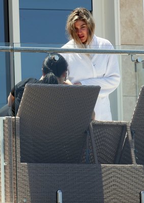 Salim's sister Mary Mehajer, pictured wearing his bathrobe on the same balcony in Vaucluse this week.