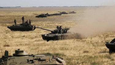 Ukrainian tanks and APCs move towards the de-facto border with Crimea near Kherson, southern Ukraine.