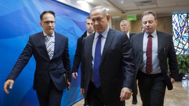Israeli Prime Minister Benjamin Netanyahu, second right, arrives for a weekly cabinet meeting in Jerusalem on Christmas Day.