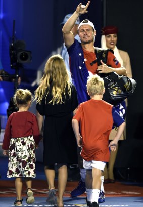 Family affair: Lleyton Hewitt waves farewell to the Rod Laver Arena crowd as he leaves, followed by his children.