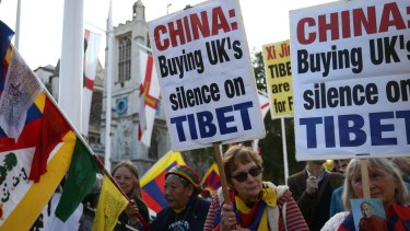 Tibetan independence activists demonstrate near Parliament in London before the visit by Chinese President Xi Jinping. 