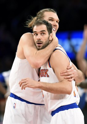 Rare win: New York Knicks duo Jose Calderon receives a hug from Lou Amundson after Calderon hit a three-point shot in the victory over the New Orleans Pelicans on Monday at Madison Square Garden.