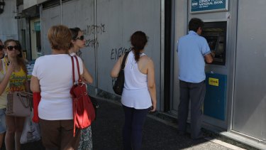 Athenians continue to queue at cash machines at banks.