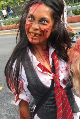 A member of the walking undead gets in to the spirit of the Brisbane Zombie Walk.