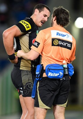 Reagan Campbell-Gillard of the Panthers is seen by a trainer after being injured.