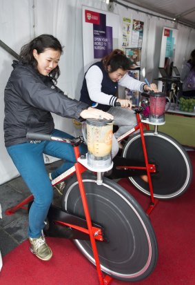 Sydney University's open day health hub sees students using pedal power to make smoothies.