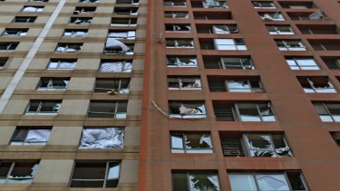 The outside of Mr Wang's apartment building in the Tianjin Economic and Development Area, showing damage to every home.