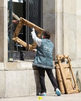 A police officer hands the packed frames of the stolen paintings, to a colleague, from outside the Paris Museum of Modern Art, in 2010. 