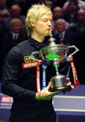 World at his feet: Neil Robertson kisses the trophy after winning the final of the World Snooker Championships in 2010.