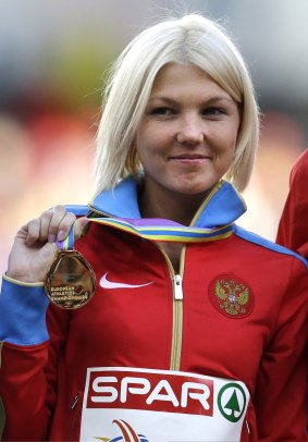 Elmira Alembekova shows the gold medal she won in the 20km walk at the European Championships in Zurich in 2014.