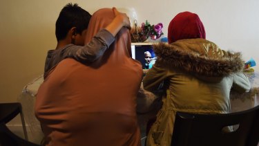 Nayser Ahmed (centre, on screen) Skypes in from Manus Island where he is in detention to his family in their home in Sydney.