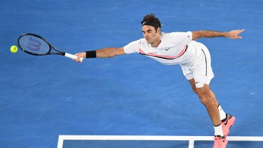 Federer is forced to stretch wide against the big-serving Cilic.