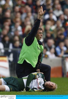 Graham Geraghty of Ireland lies unconsious as an attendant call for help after being tackled by Danyle Pearce in 2006.