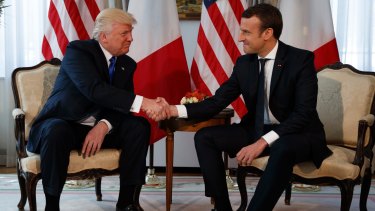 US President Donald Trump shakes hands with French President Emmanuel Macron during a meeting at the US embassy in Brussels. 