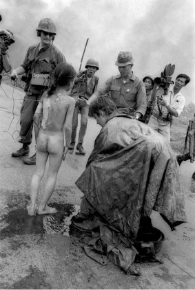 In this  June 8, 1972, photo, television crews and South Vietnamese troops surround nine-year-old Kim Phuc after she had been burnt by flaming napalm. 