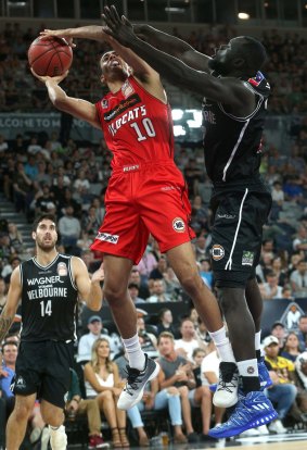 Drawing the foul: Perth's Dexter Kernich-Drew under pressure from Melbourne's Majok Majok.