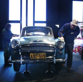 Car exhibition: Volunteers clean a 1955 Hillman Minx.